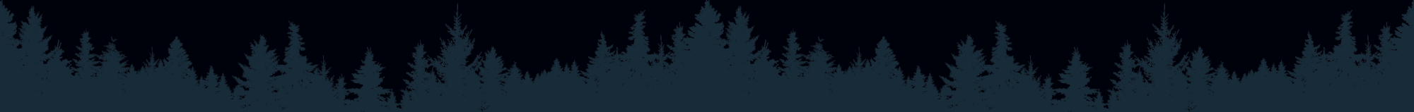 Silhouette of a dense forest against a dark sky.